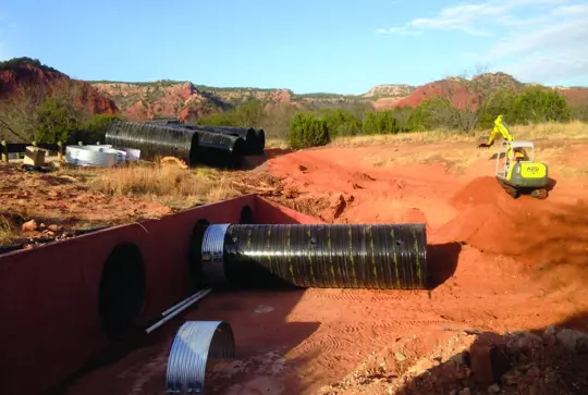 A culvert being relined with ULTRA FLOW corrugated metal pipe.