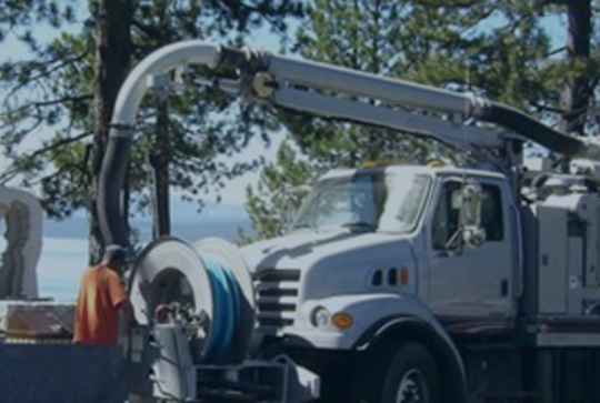 A vacuum truck performing maintenance on a stormwater management system.