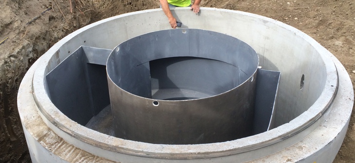 A worker installing a hydrodynamic separator.